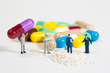 miniature people on the drugs or pils on white,medical conceptの写真素材
