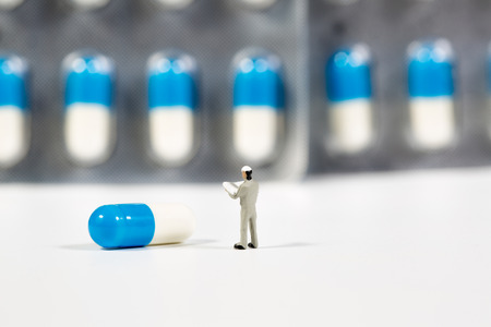 miniature people on the drugs or pils on white,medical conceptの写真素材