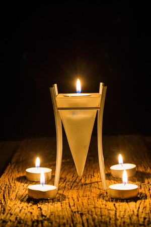 candle light in dark on wood textureの写真素材