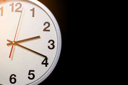 white clock on black background