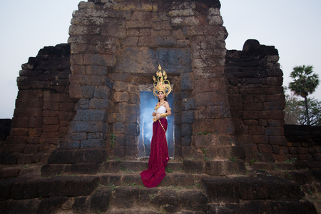 Asian woman wearing cambodia traditional dress in stone wallの写真素材