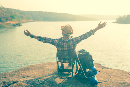 Asian man backpack in nature background, Relax timeの写真素材