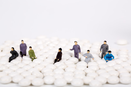 miniature people with white pillの写真素材