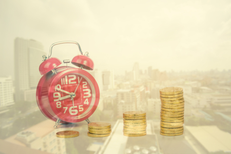 alarm clock and gold coin on white background,double exposureの写真素材