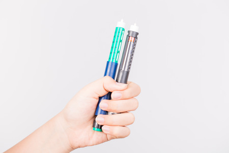 hand holding in sulin pen on white backgroundの写真素材