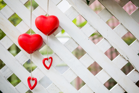 red heart shape haning on wod backgroundの写真素材