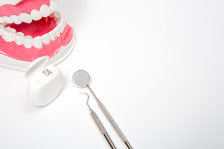 dental tool and dental floss on white backgroundの写真素材