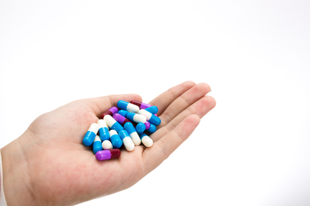 hand holding drug capsule on white backgroundの写真素材