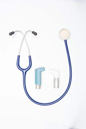 respiratory inhaler and stethoscope on white backgroundの写真素材