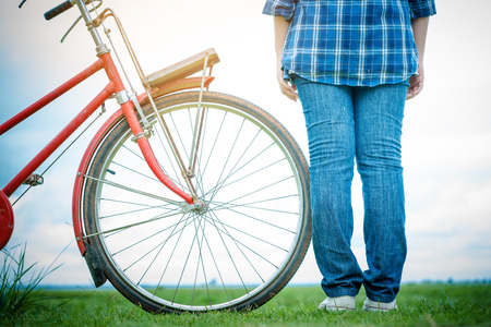young woman with red bicycleの写真素材