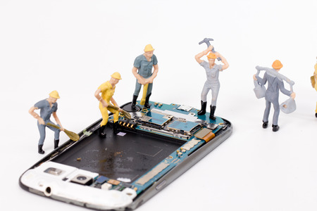 miniature people repair smartphone crack