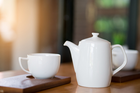 white cup of coffee and tea potの写真素材