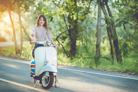 tourist and classic scooter on roadwayの写真素材
