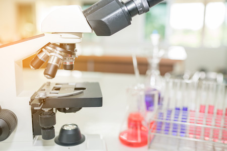 Microscope on the table in laboratory room with laboratory equipmentの写真素材