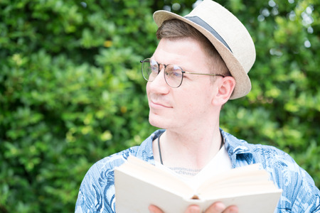 caucasian man eading book  in the gardenの写真素材