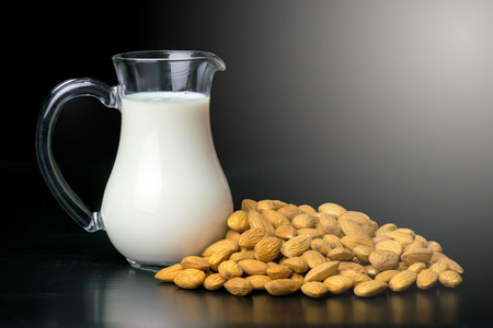 almond and almond milk on black backgroundの写真素材