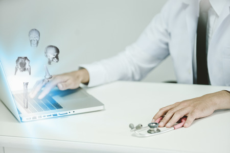 caucasian man doctor using laptop