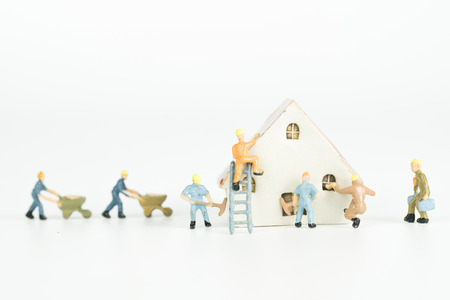 Group of engineer workers are repairing house on whute background.の写真素材