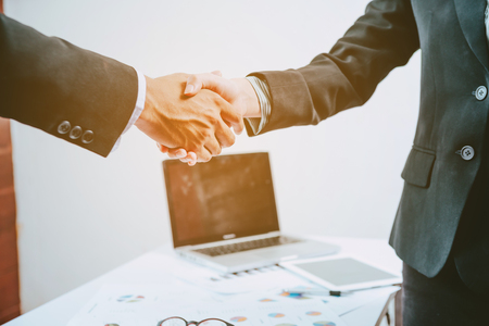 two businessman shaking hands at the working placeの写真素材