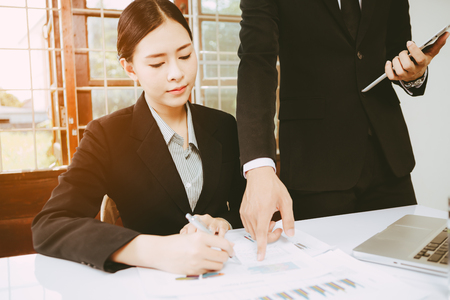 two young business partners consulting at meetingの写真素材