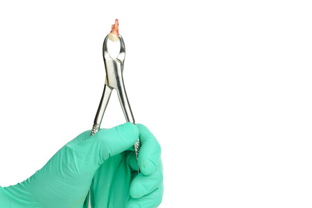 dentist hand holding clamp tooth removal on white background
