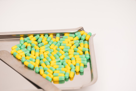 medical drug capsule on medical tray on white backgroundの写真素材