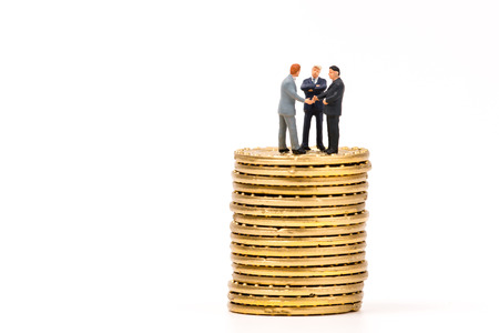 miniature people on calculator and shecking hand,business conceptの写真素材