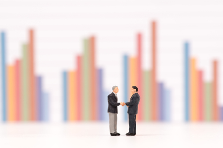 miniature people  shecking hand on business chart ,business conceptの写真素材
