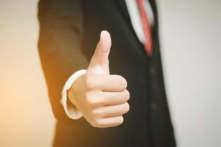 Businessman showing thumbs up in office.の写真素材