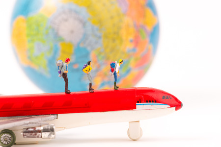 Miniature figure person backpack team, travelers  standing on airplane,tourism concept