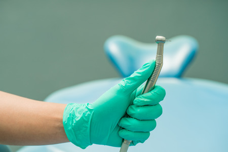Dentist hand holding dental tool to clean oral cavity,tartar drillの写真素材