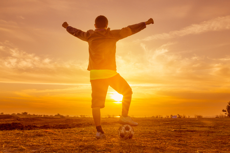 silhouette football player at sunset or sunrise backgroundの写真素材