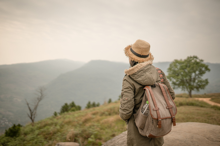 backpacker standing on the rock with beautiful nature backgroundの写真素材