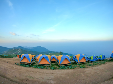 colorful tent on the hill under blue skyの写真素材
