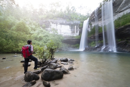 backpacker standing infront of waterfallのeditorial素材