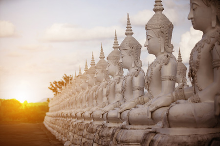Row white buddha statue with sun lightの写真素材