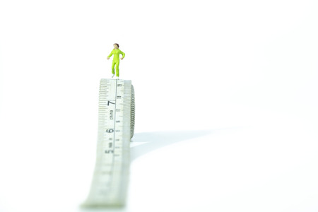 Miniature people running on measure tape. healthy conceptの写真素材