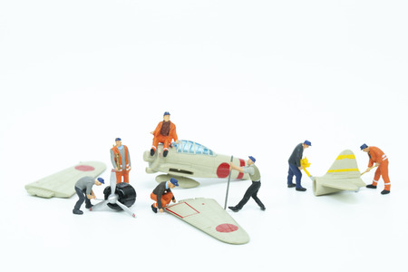 Miniature mechanics repairing toy airplane,concept of the workshopの写真素材
