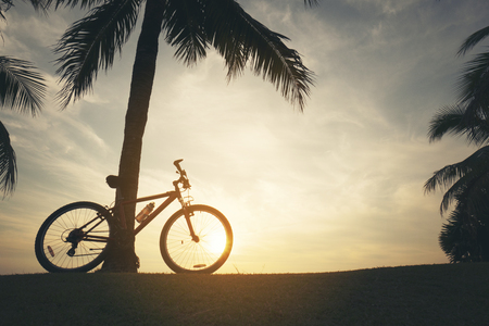 Silhouette bicycle with sunset or sunrise backgroundの写真素材