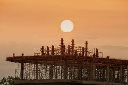 The silhouette iof tower at the real estate and building construction site with sunset or sunrise...