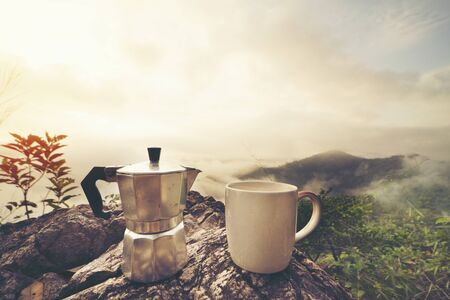 Coffee cup ,moka pot, with mountain  and fog backgroundの写真素材