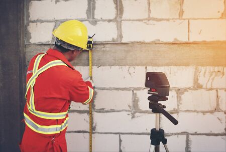 Technician with Laser measurement level during work