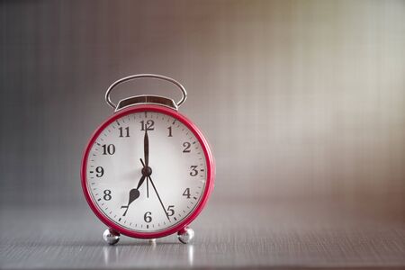 red alarm clock  in dark background