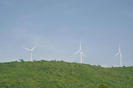 wind turbines on the hill with blue sky