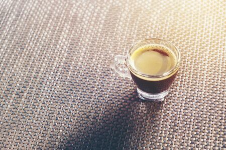 Coffee cup and saucer on bamboo weaveの写真素材
