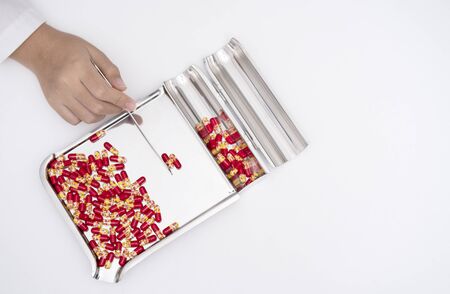 Pharmacist is counting drug capsule on counting drug tray,top viewの写真素材