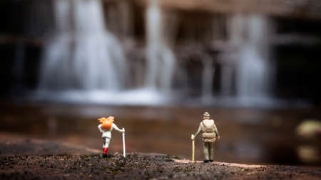 miniature backpacker with waterfall background,tourism conceptの写真素材