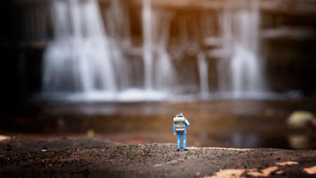 miniature backpacker with waterfall background,tourism conceptの写真素材