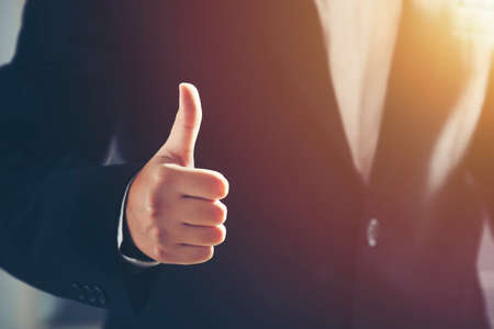 Business man shows thumb up