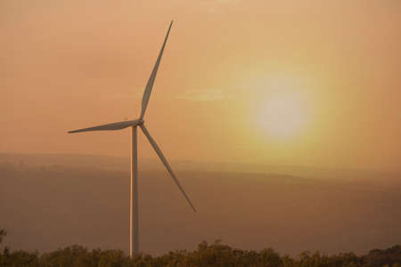 Wind turbine with sunset background